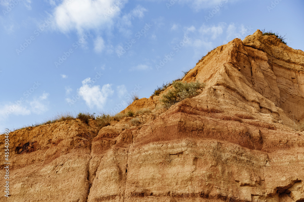 Sand stone and rocks cliff against blue sky