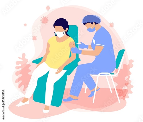 A masked nurse in a medical suit, gloves, mask gives an injection of a vaccination for immunization coronavirus to a pregnant woman. Protection the spread of covid 19. The use of vaccines for pregnant