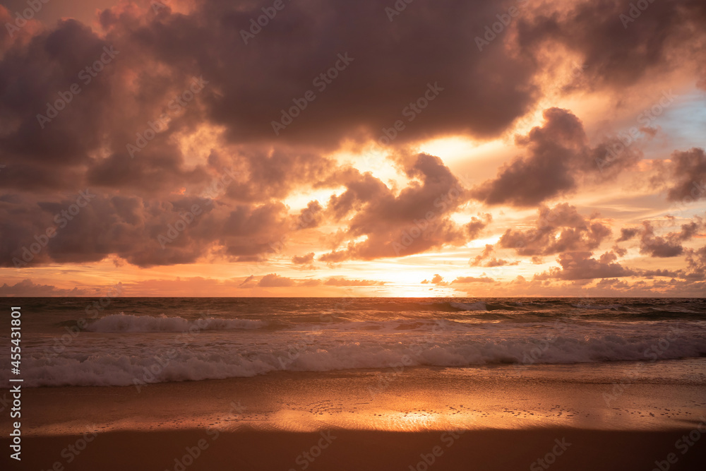 Orange sundown and golden sunset sky.Sunset turquoise colored water on the beach.