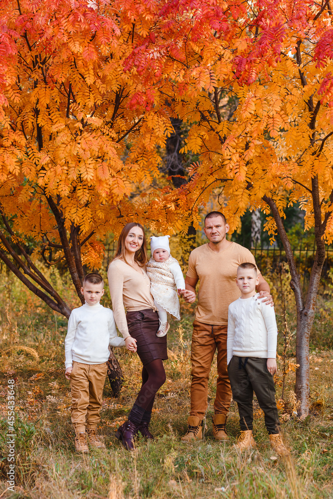 happy beautiful family of five on walk in the autumn against the background of yellow leaves of mountain ash happy beautiful family of five on walk in the autumn against the background of yellow leaves of mountain ash
