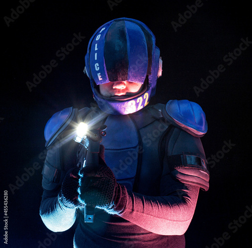 Cyberpunk future concept. Police officer cop, halfman aims around in dar. Bionic cyborg robot is in fume, smoke. Weapon gun with lantern. Science fiction scene, fantasy, sci. photo
