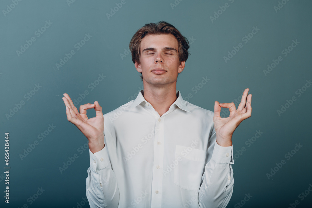 Portrait european young man portrait at studio with ok mudra sign yoga zen concept Portrait european young man portrait at studio with ok mudra sign yoga zen concept