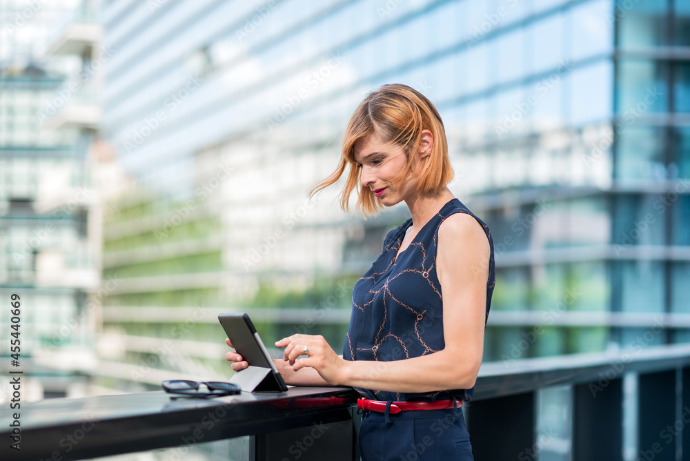 Fototapeta premium Woman with tablet in city
