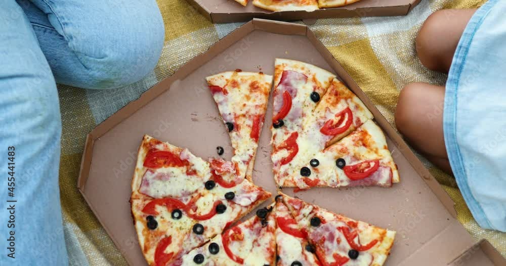 Sharing pizza, hands taking a piece of pizza from a box outdoor, Sharing pizza, hands taking a piece of pizza from a box outdoor,