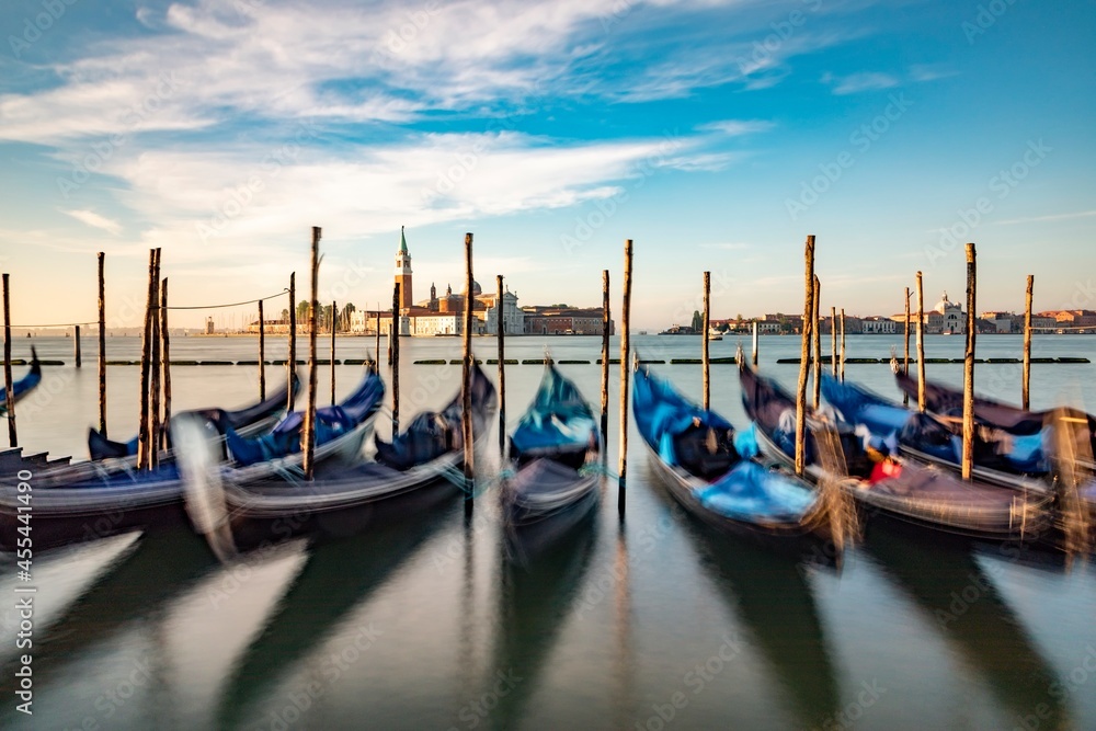 blurred gondolas at San Marco with view in early morning to island San Georgio Maggiore in Venice