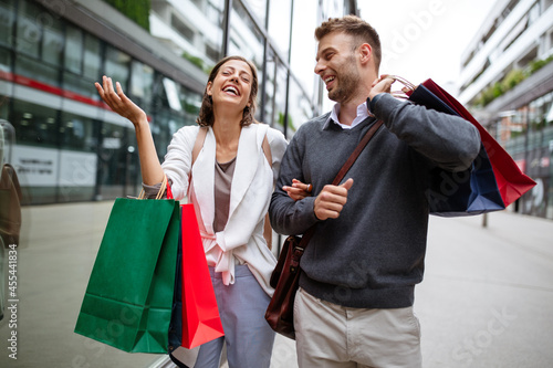 Beautiful young couple enjoying in shopping, having fun together.