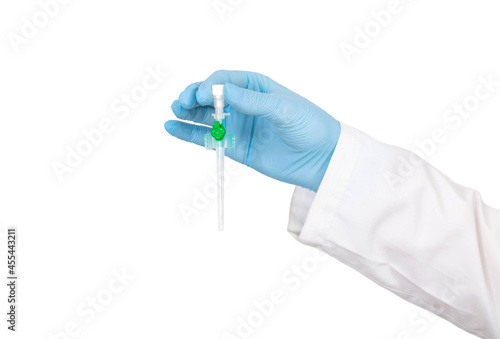 Doctor's hand in a medical gown and a blue glove with a medical catheter on a white background, isoyal. Concept for the use of catheters in plastic surgery