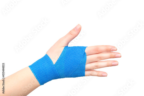Blue elastic bandage on the wrist joint of the hand on a white background, isolate. Concept of wrist fixation in case of dislocation and contusion, compression photo