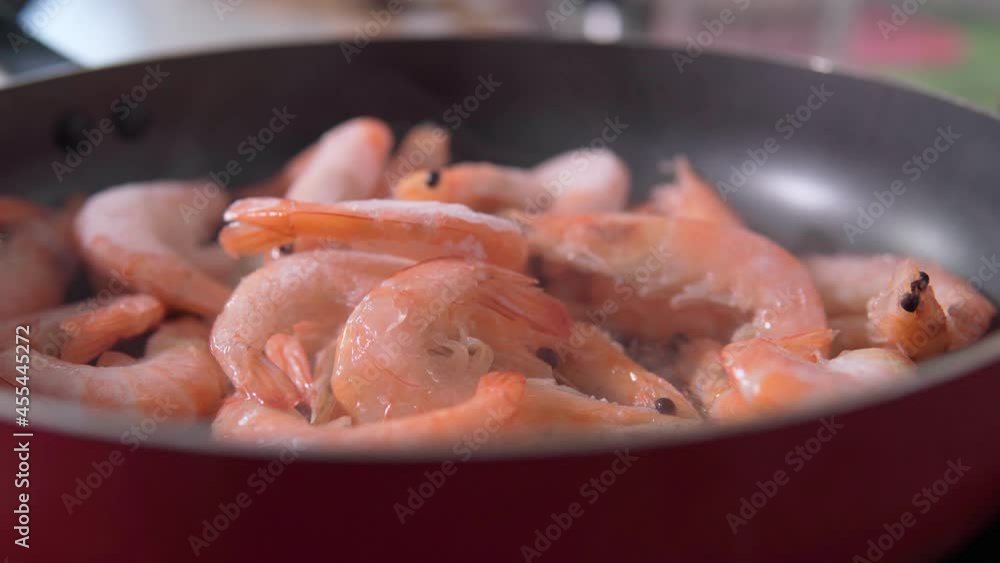 Cooking shrimp, roasted shrimps in frying pan close up. Cooking seafood in the kitchen Cooking shrimp, roasted shrimps in frying pan close up. Cooking seafood in the kitchen