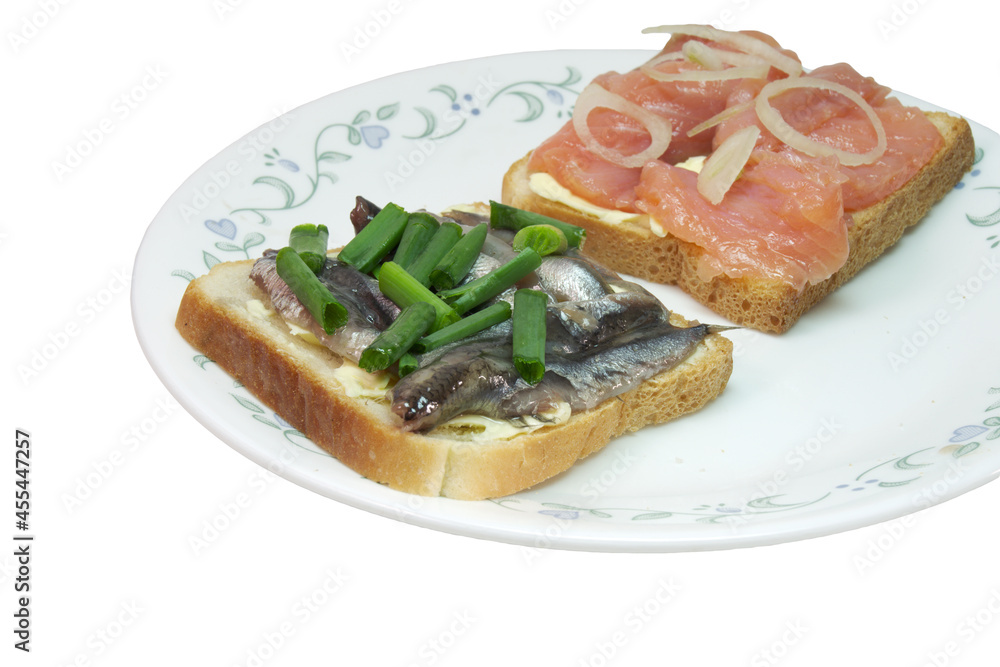 sandwich pair with slices of salted salmon and small silvery sprats, on white toast bread with butter, seasoned with chopped shallots. closeup. isolated on white background sandwich pair with slices of salted salmon and small silvery sprats, on white toast bread with butter, seasoned with chopped shallots. closeup. isolated on white background