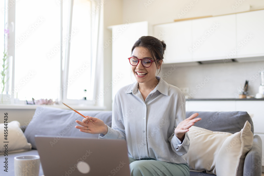 Smiling teacher freelancer holding video call with students, explaining foreign language. Distant education, e-learning. Smiling teacher freelancer holding video call with students, explaining foreign language. Distant education, e-learning.