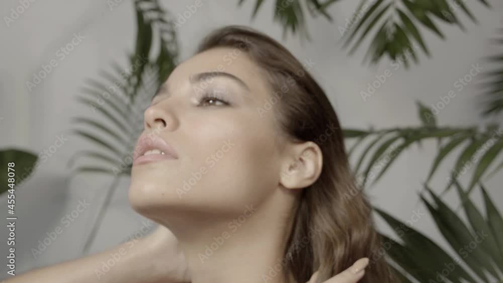 Young woman in the tropics. Skin and hair care. Natural cosmetic. Spa treatments. Natural beauty. Eco friendly. Thick, healthy hair. Woman's face and palm leaves. Young woman in the tropics. Skin and hair care. Natural cosmetic. Spa treatments. Natural beauty. Eco friendly. Thick, healthy hair. Woman's face and palm leaves.