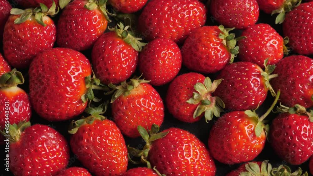 A lot of ripe and fresh strawberry. Closeup. Rotating A lot of ripe and fresh strawberry. Closeup. Rotating