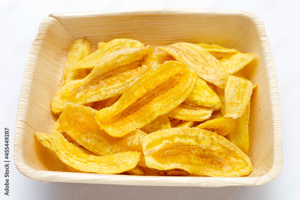 Banana slice chips in plate on white background Banana slice chips in plate on white background