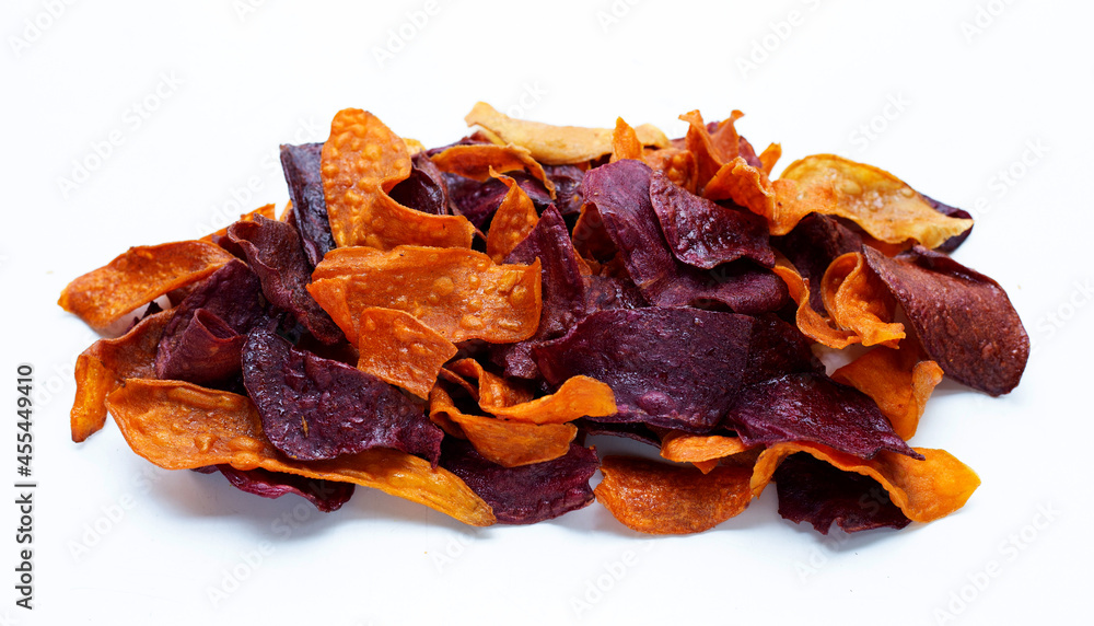Purple and yellow sweet potato chips on white background.