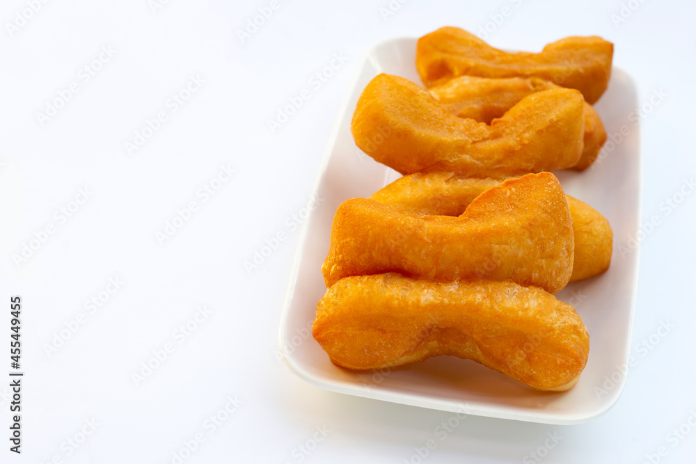 Deep-fried dough sticks or chinese bread sticks on white background. Deep-fried dough sticks or chinese bread sticks on white background.