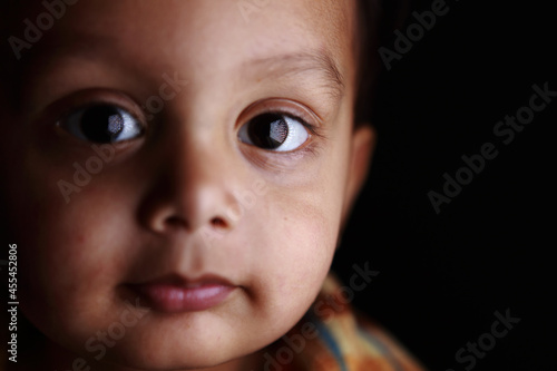 Closeup Portrait 2 year old Indian Boy with interesting catch-light photo