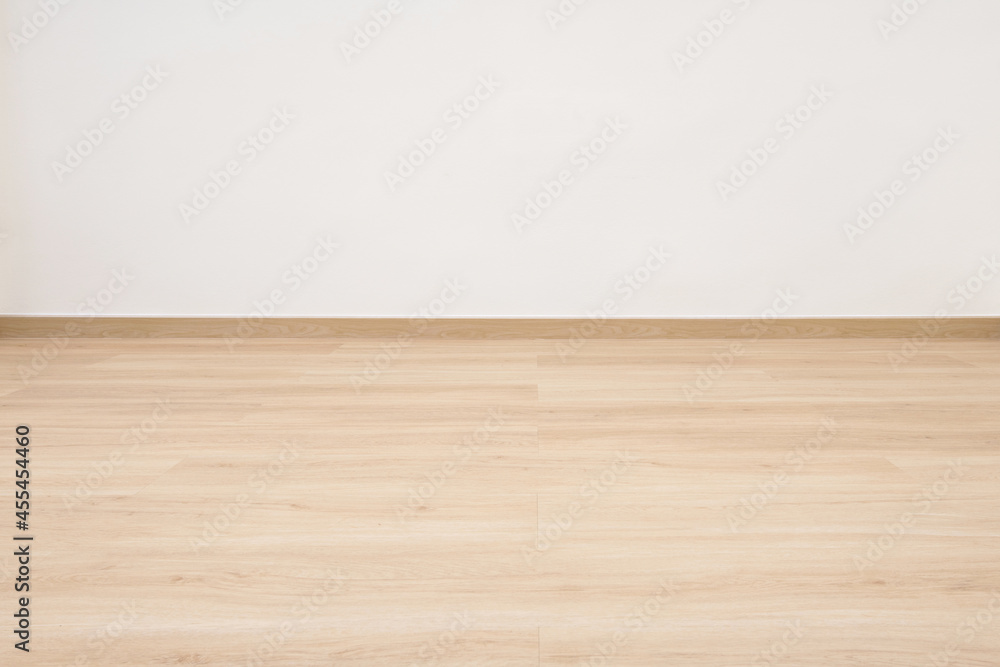 Empty wooden floor with white concrete wall. Empty wooden floor with white concrete wall.
