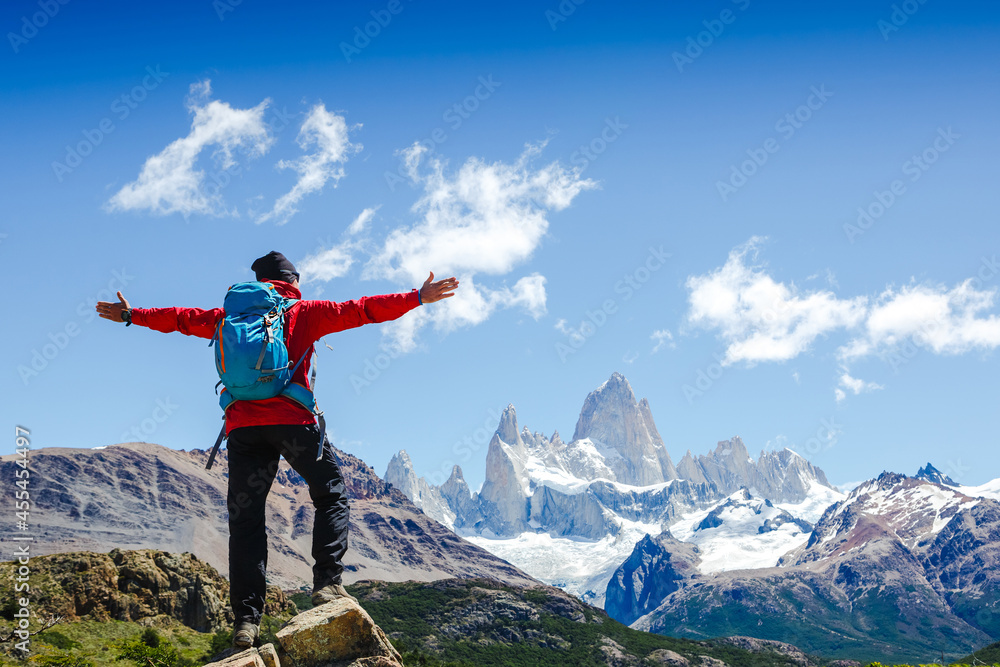 Active hiker hiking, enjoying the view, looking at Patagonia mountain landscape. Fitz Roy, Argentina. Mountaineering sport lifestyle concept Active hiker hiking, enjoying the view, looking at Patagonia mountain landscape. Fitz Roy, Argentina. Mountaineering sport lifestyle concept
