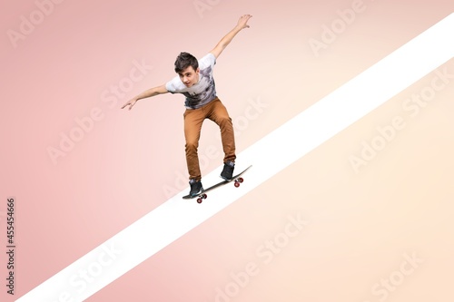A person riding on a skateboard on pastel background. Modern design, art collage.