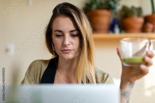 Relaxed woman working from home on her laptop photo