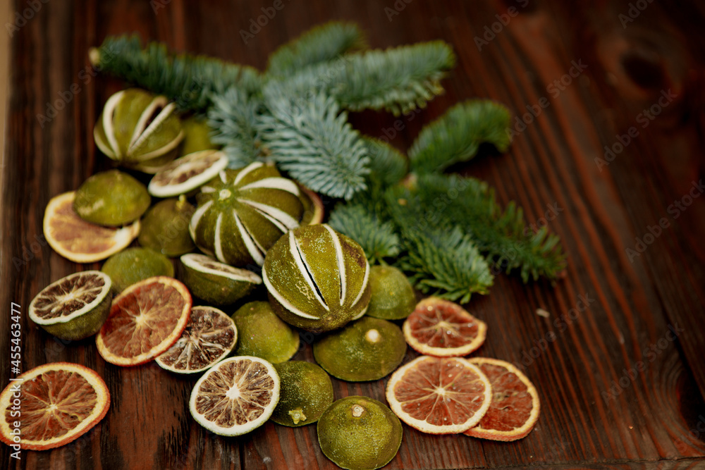 elements of Christmas decor (dried lemon, lime and orange wedges on a wooden board) elements of Christmas decor (dried lemon, lime and orange wedges on a wooden board)