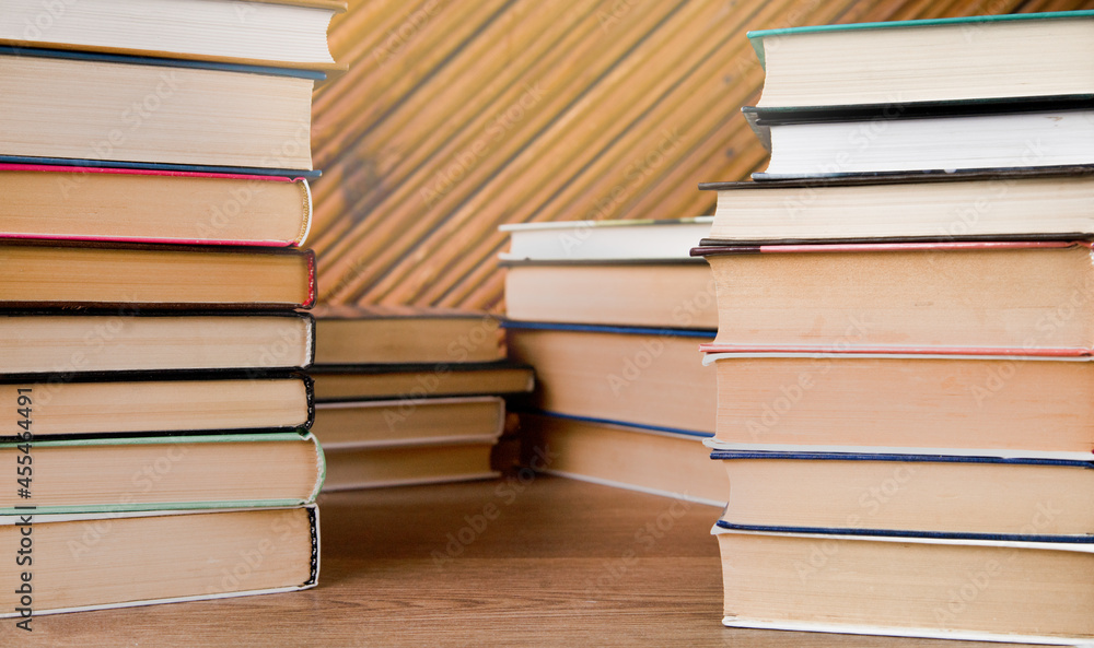Stacks of books on a wooden background. Stacks of books on a wooden background.