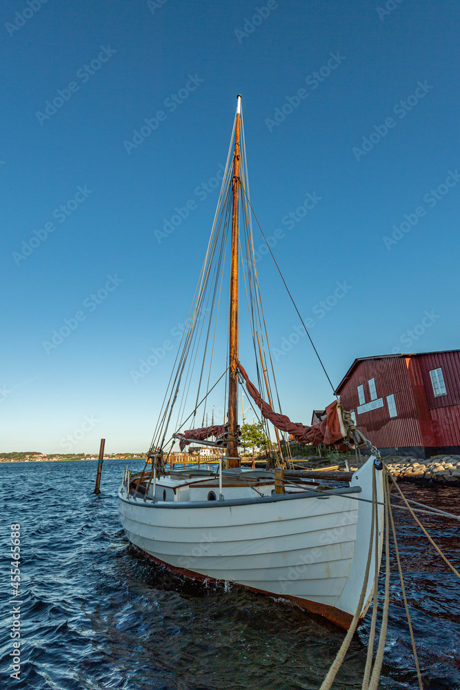 Denmark, Middelfart, 04-09-2021- Old and new wooden dinghies, are moored