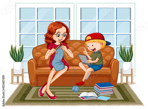 Boy sitting on couch learning from tablet with his mother