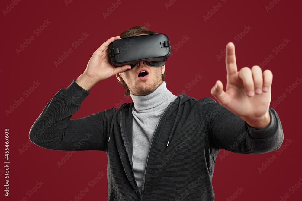 Amazed guy touching virtual screen Amazed guy touching virtual screen