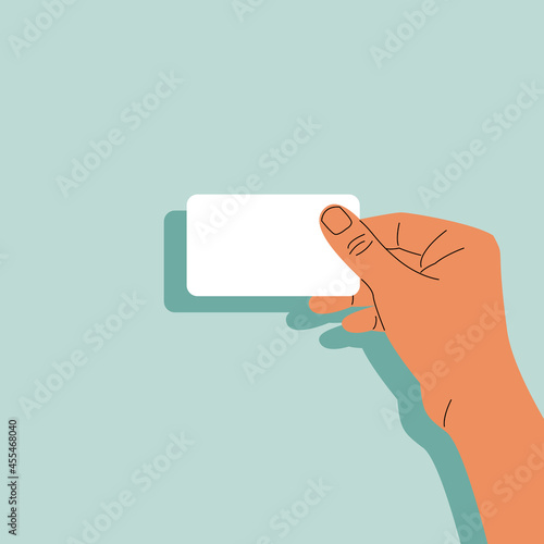 Man's hand holds a white blank bank card or business card. Stock vector illustration in flat style with copy space. 