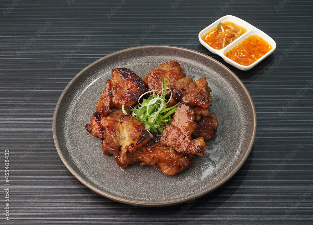bbq grilled tender pork chop meat with sauce on dark grey wood background dim sum halal menu