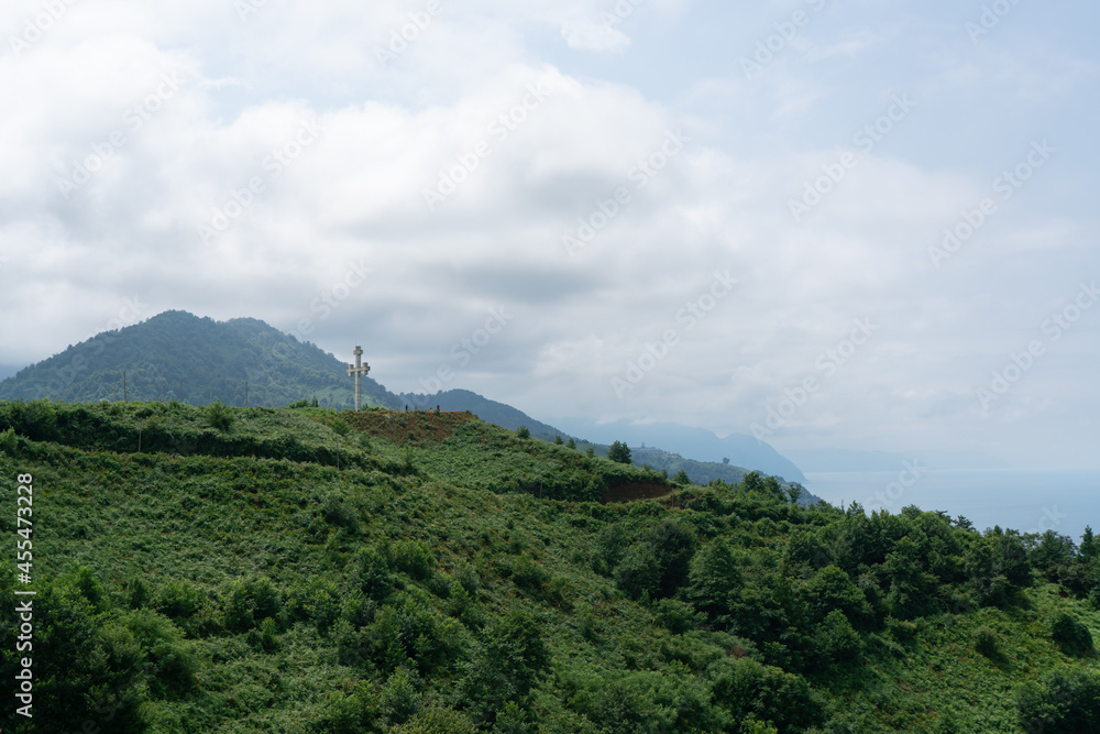 Christian cross on a mountain and figures