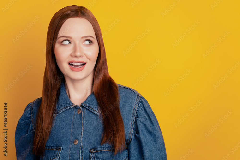 Portrait of excited crazy cute lady look empty space open mouth on yellow background Portrait of excited crazy cute lady look empty space open mouth on yellow background