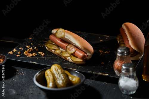 Tasty hot dog with smoked frankfurter and gherkin photo