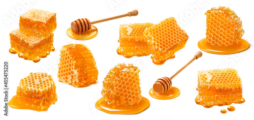 Honeycomb set isolated on white background. Wooden honey dippers photo