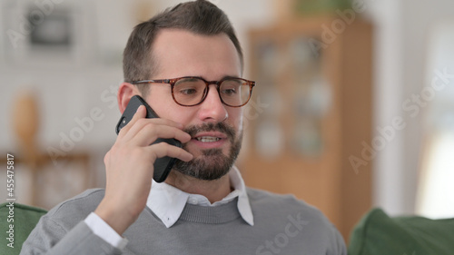 Middle Aged Man Talking on Phone at Home