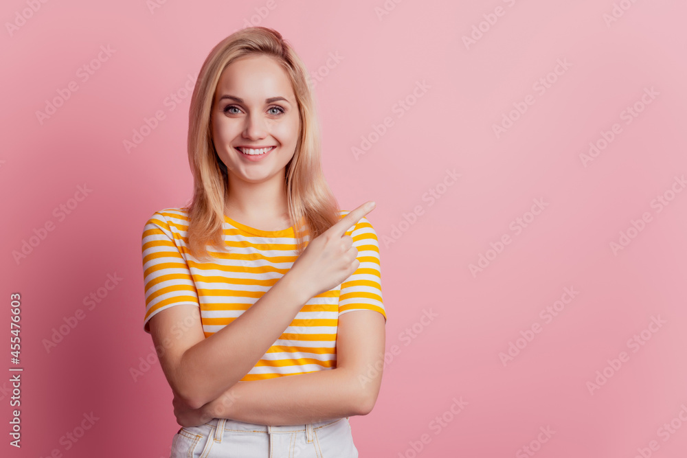 Portrait of adorable cheerful girl indicate forefinger empty space on pink background Portrait of adorable cheerful girl indicate forefinger empty space on pink background