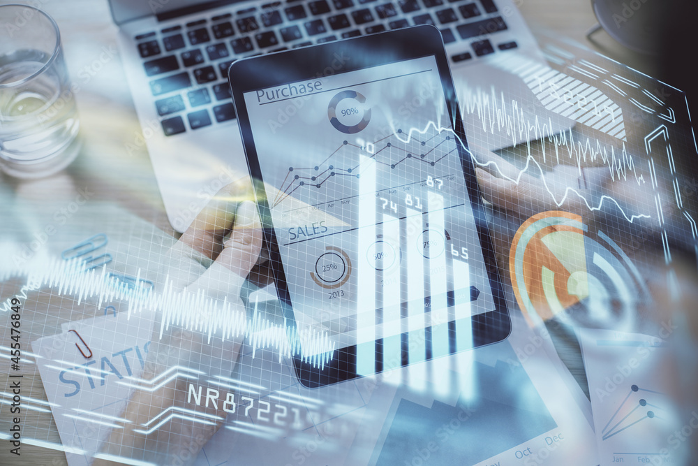 Double exposure of man's hands holding and using a digital device and tech theme hologram drawing. Technology concept. Double exposure of man's hands holding and using a digital device and tech theme hologram drawing. Technology concept.