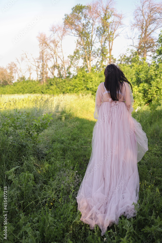 Beautiful woman in a long dress in the forest Beautiful woman in a long dress in the forest