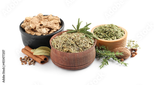 Different natural spices and herbs on white background
