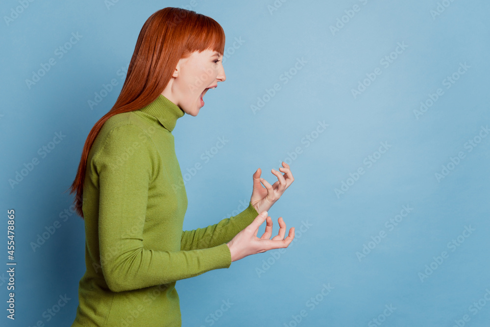 Profile side photo of mad woman scream empty space isolated over blue background Profile side photo of mad woman scream empty space isolated over blue background