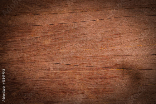 Old wood texture background with natural cracks. Dark brown wood plank is used for background. 
