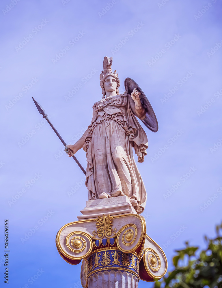 Athena marble statue the ancient goddess of wisdom and knowledge on Ionian order column, Athens Greece Athena marble statue the ancient goddess of wisdom and knowledge on Ionian order column, Athens Greece