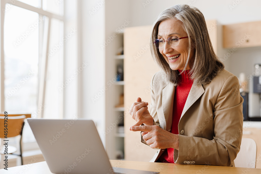Smiling mid aged woman entrepreneur on a video call Smiling mid aged woman entrepreneur on a video call