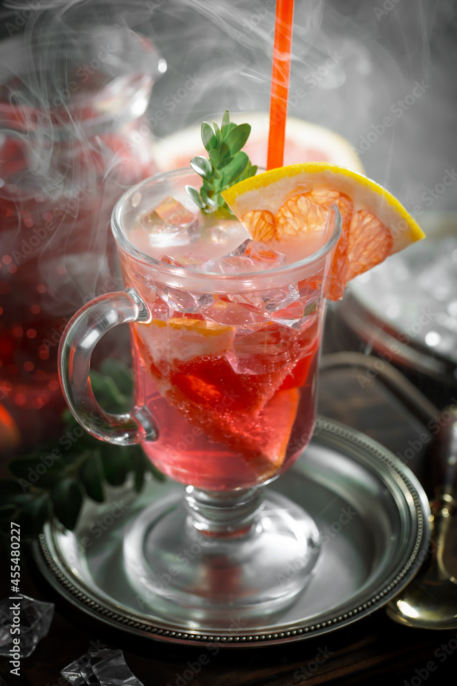 Fruit cocktail, in a glass with natural healthy fruits on a table with kitchen accessories. Fruit cocktail, in a glass with natural healthy fruits on a table with kitchen accessories.