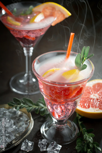 Fruit cocktail, in a glass with natural healthy fruits on a table with kitchen accessories.