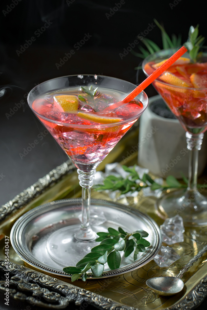 Cocktail in a glass with fruit on an old background. Cocktail in a glass with fruit on an old background.