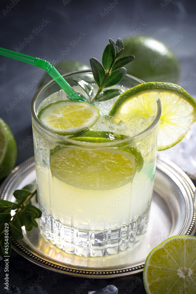 Fototapeta premium Fruit cocktail, in a glass with natural healthy fruits on a table with kitchen accessories.
