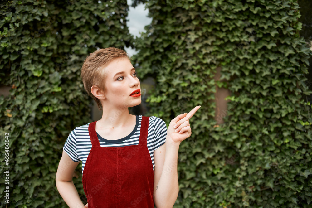 woman with short hair walking in the park a cup of coffee summer lifestyle woman with short hair walking in the park a cup of coffee summer lifestyle